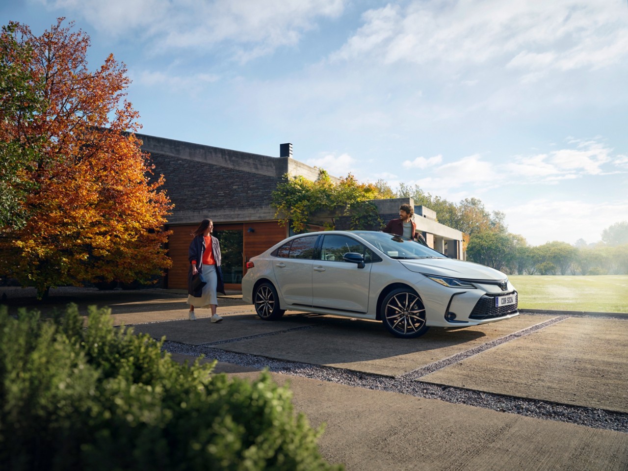 Toyota Corolla Hatchback driving down the road